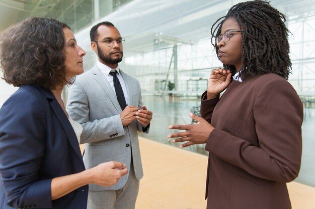 African American manager explaining project details to partners