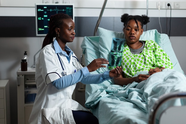 African american medic analyzing x ray scan for diagnosis