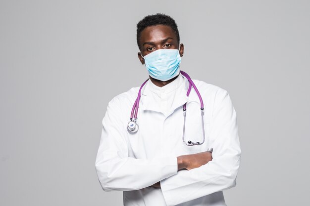 African-American medical doctor man with mask isolated on gray background