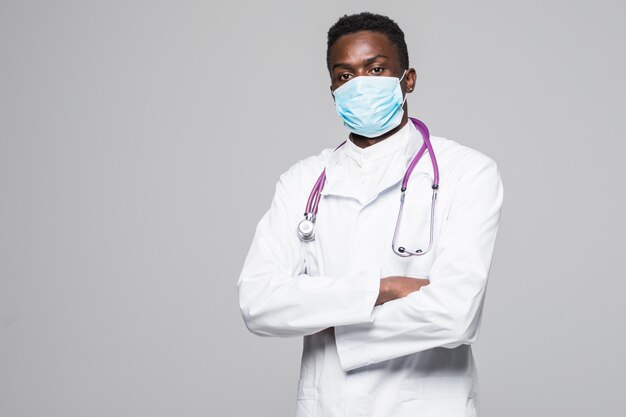 African-American medical doctor man with mask isolated on gray background