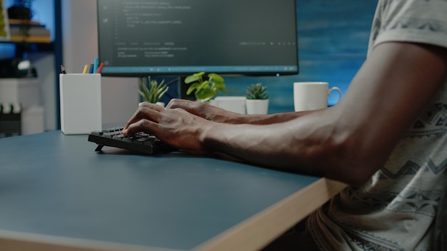 African american person programming codes for firewall server on computer. Black programmer using coding interface with binary code for website development. african american man working with data