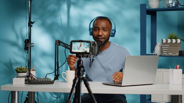 African american vlogger using camera to record video