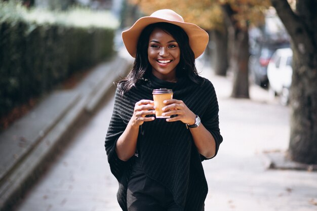 African american woman drinking coffee and talking on the phone