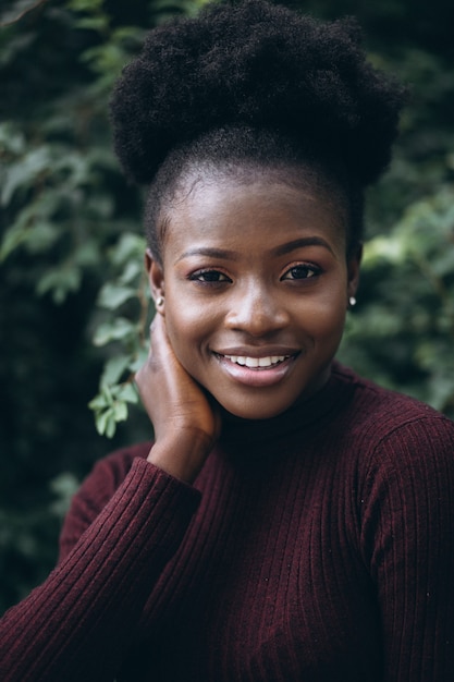 African american woman on a green bush background