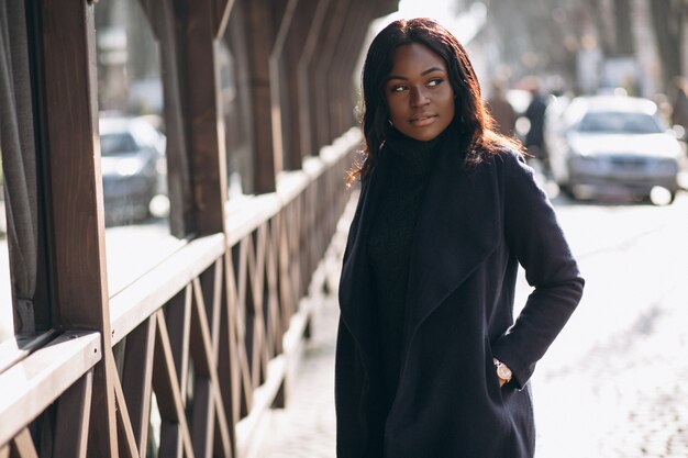 African american woman model in coat in the street