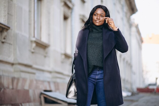 African american woman model in coat in the street