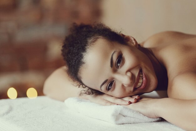 African American woman receiving a relaxing massage at the spa