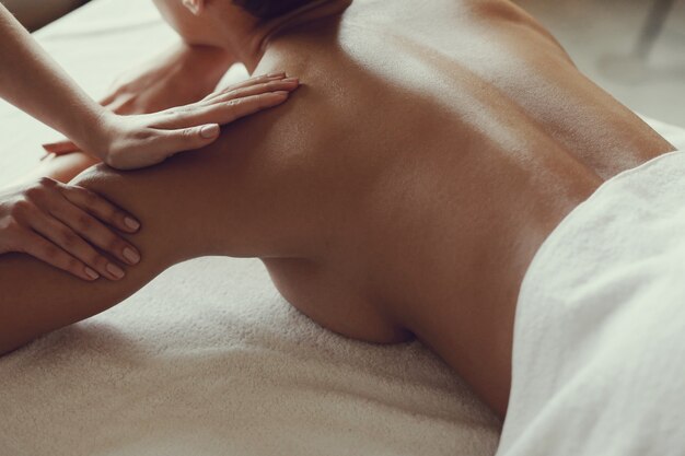 African American woman receiving a relaxing massage at the spa