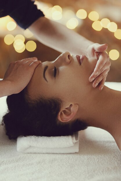 African American woman receiving a relaxing massage at the spa