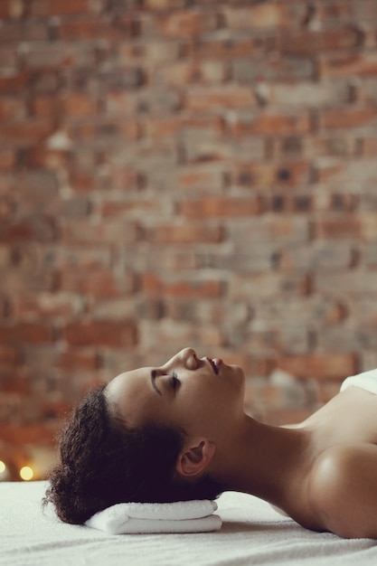 African American woman receiving a relaxing massage at the spa