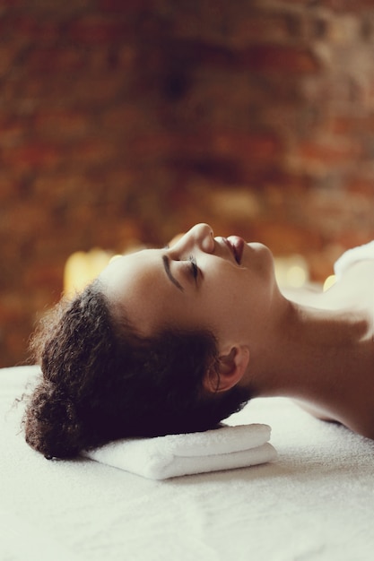 African American woman receiving a relaxing massage at the spa