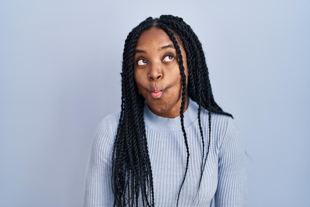 Free Photo  African american woman standing over blue background making fish  face with lips crazy and comical gesture funny expression