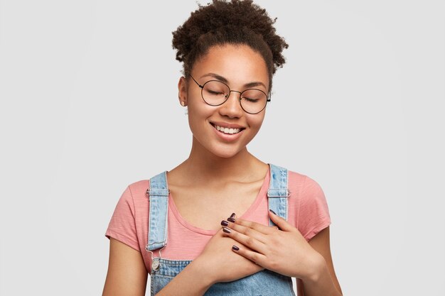 African-American woman wearing denim overalls