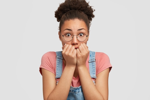 African-American woman wearing denim overalls