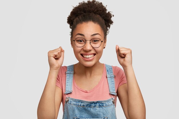 African-American woman wearing denim overalls