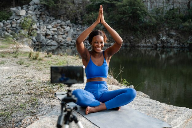 African american yoga teacher practicing outdoors