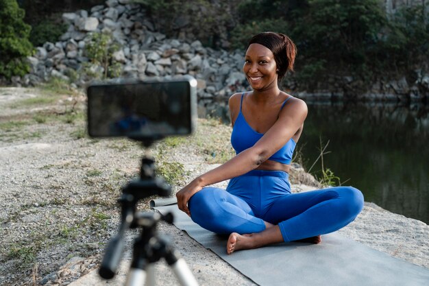 African american yoga teacher practicing outdoors