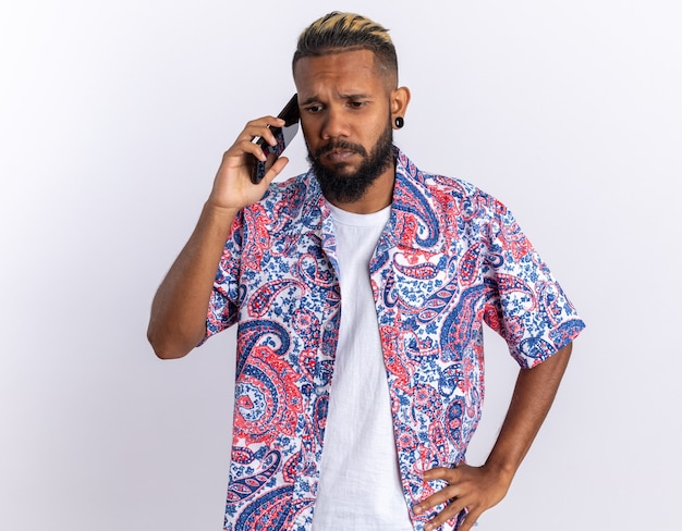 African american young man in colorful shirt looking confused and very anxious