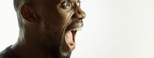 African-american young man's close up shot on studio background, flyer