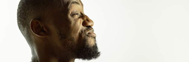 African-american young man's close up shot on studio background