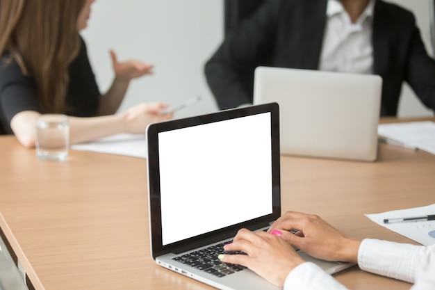 African businesswoman analyzing statistics on laptop at group meeting