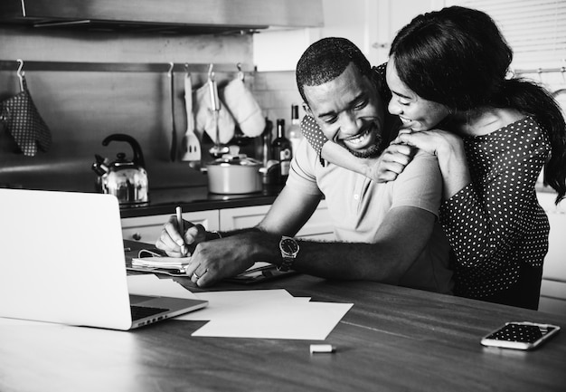 African couple hugging together in the kitchen