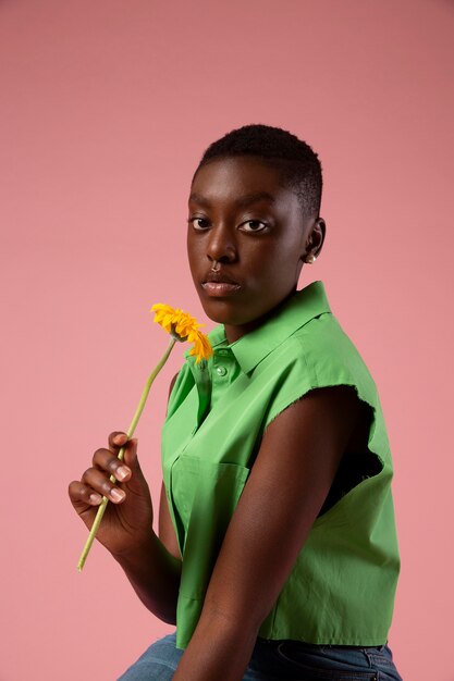 African gender fluid person posing in a green shirt