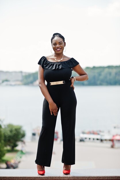 African girl posed at street of city wear on black