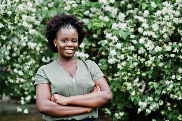 African girl posed at street of city wear on green blouse and blue pants