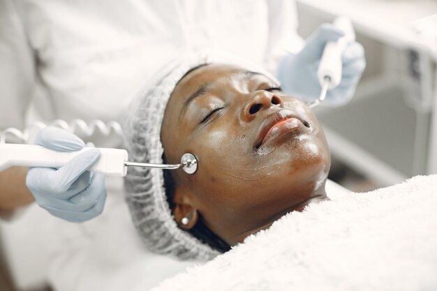 African girl. Woman on couch. Lady at  beautician.