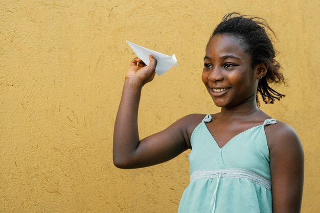 African girlplaying with airplane