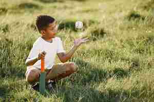 Free photo african little boy. child in a summer park. kid plays in american football.