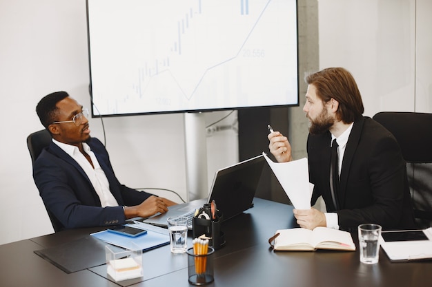 African man in a black suit. International partners.