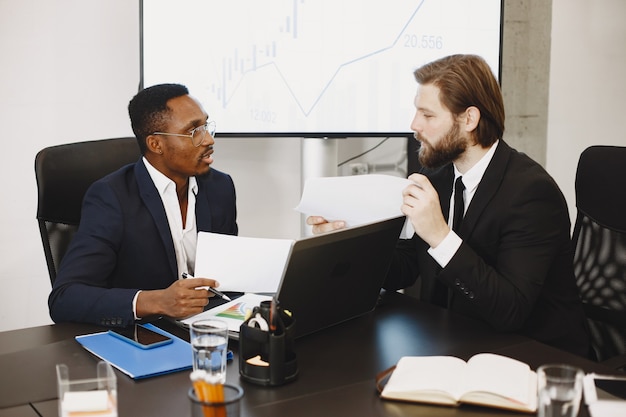 African man in a black suit. International partners.