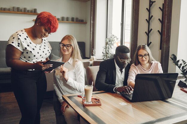 African man. Guy in a black suit. Students with a laptop. Girl in white blouse.