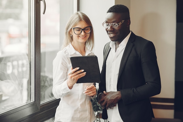 African man. Guy in a black suit. Students with a talet. Girl in white blouse.