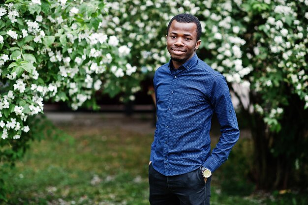 African man posed at street of city wear on blue shirt and black pants