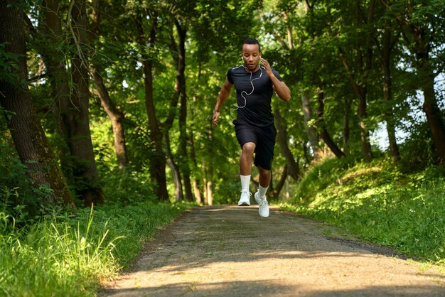 African man running in park walkway