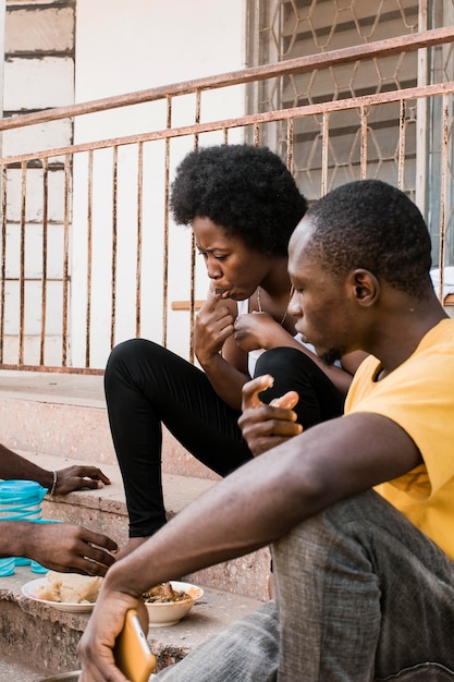 Popolo africano che mangia sulle scale