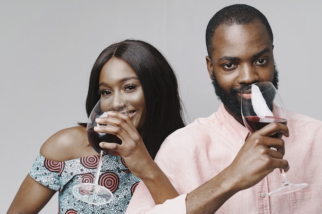 Free photo african people in a studio. white wall.  people with vine.