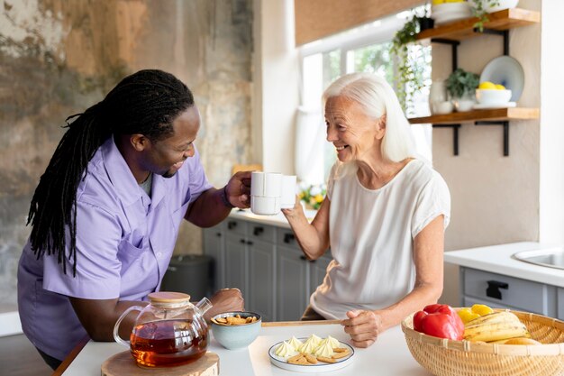 African social worker helping a senior woman