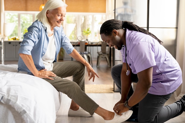 African social worker taking care of a senior woman