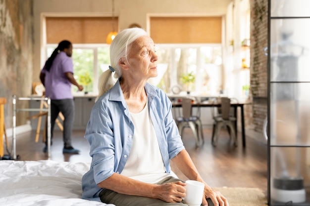 African social worker taking care of a senior woman