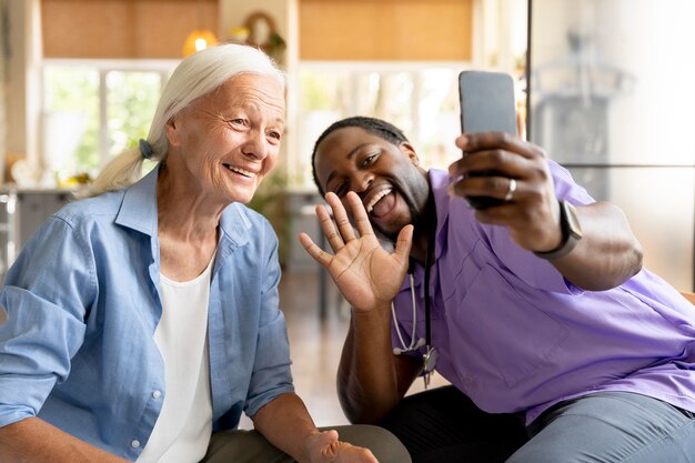 African social worker taking care of a senior woman