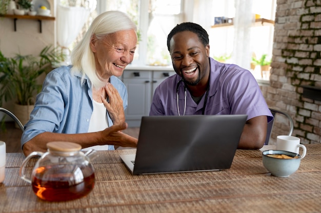 African social worker taking care of a senior woman