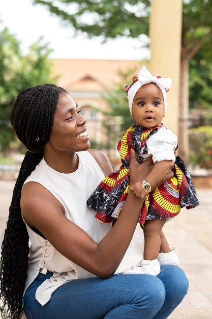 African woman holding little girl