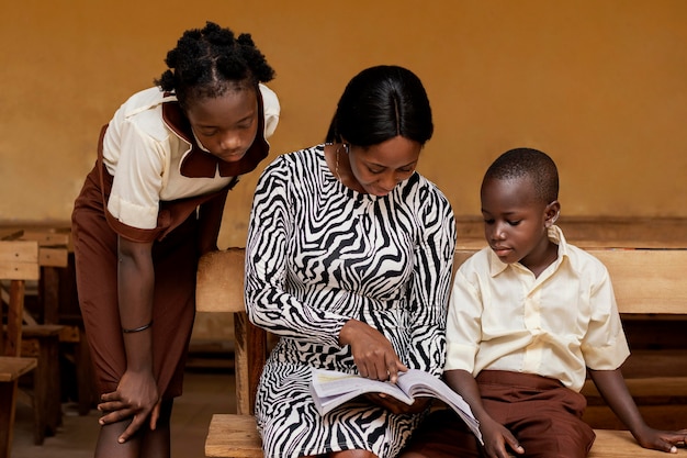 African woman teaching kids in class