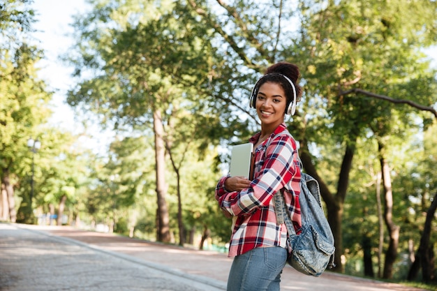 Free photo african woman walking outdoors in park