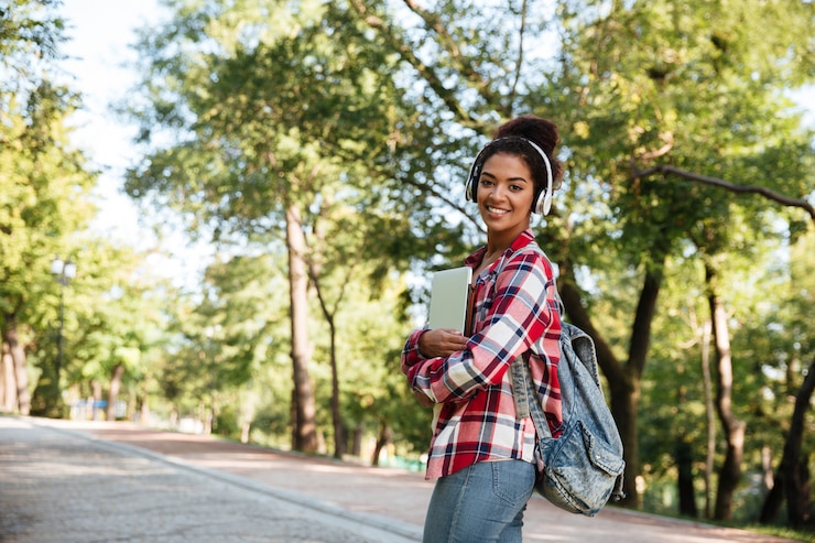 Free Photo african woman walking outdoors in park
