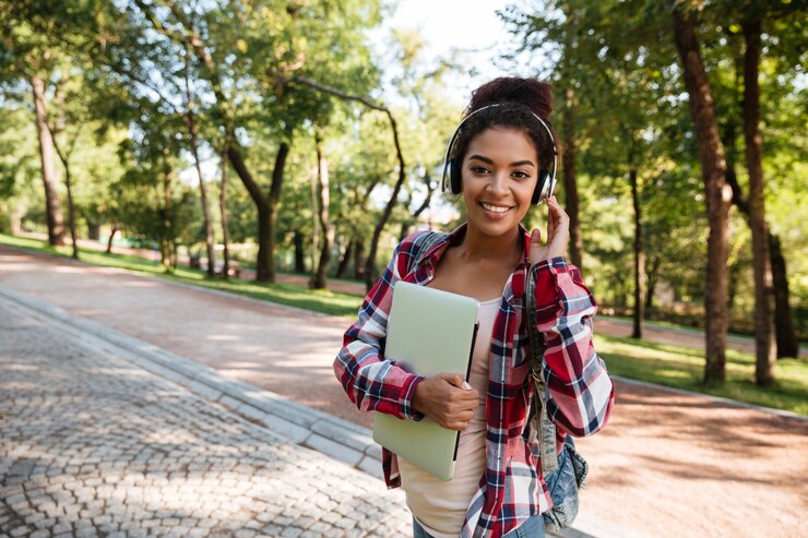 Free Photo african woman walking outdoors in park